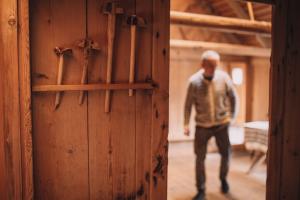 Man in the old wooden house Blásastova in norðagøta, Faroe Islands